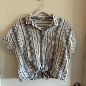 Flowy, cotton, button up top with a front tie.